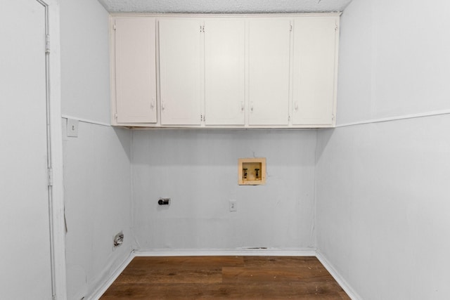 clothes washing area featuring dark wood-type flooring, cabinets, washer hookup, and hookup for an electric dryer