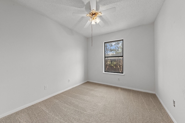 carpeted spare room featuring a textured ceiling and ceiling fan