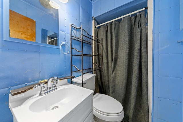 bathroom with vanity, toilet, and walk in shower