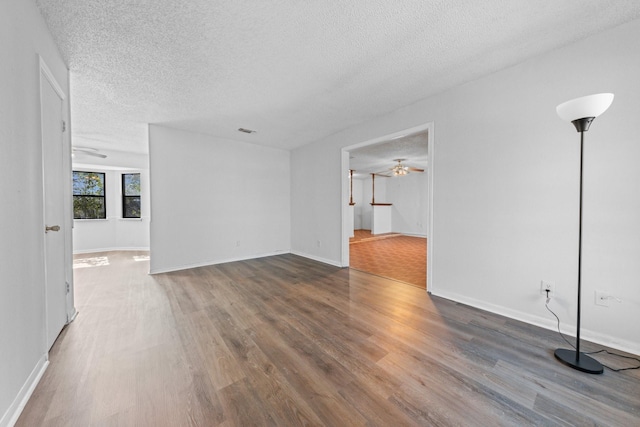 unfurnished room with ceiling fan, hardwood / wood-style floors, and a textured ceiling