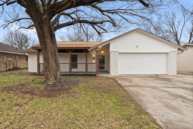 ranch-style house featuring a garage, concrete driveway, brick siding, and a front yard