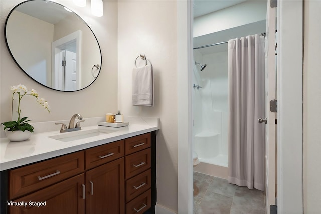 bathroom featuring toilet, a stall shower, and vanity