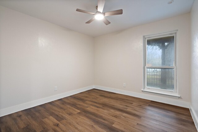 empty room featuring ceiling fan, a raised ceiling, and hardwood / wood-style floors