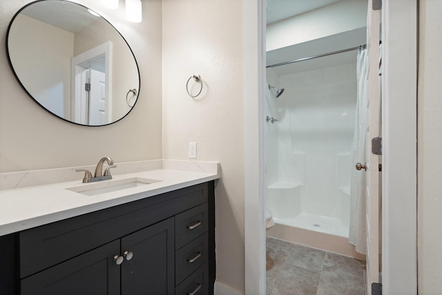 bathroom featuring vanity and curtained shower