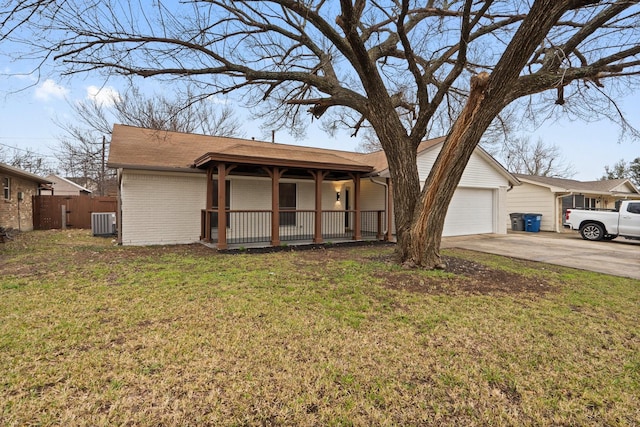 single story home featuring a porch, a garage, a front yard, and central air condition unit