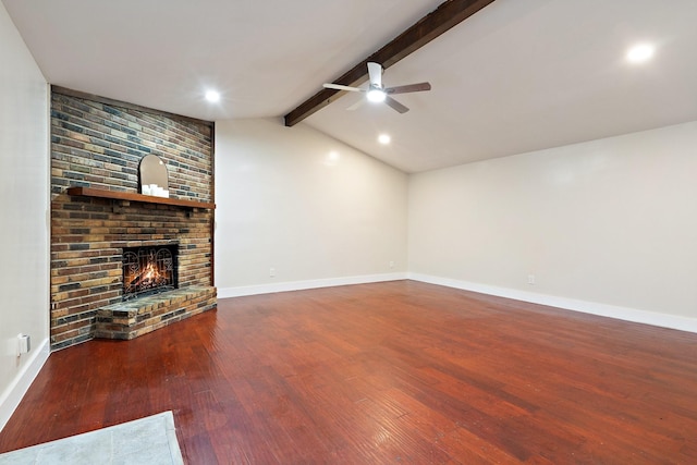 unfurnished living room featuring dark hardwood / wood-style flooring, a brick fireplace, vaulted ceiling with beams, and ceiling fan