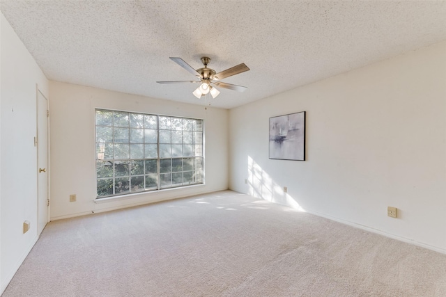 carpeted empty room with a textured ceiling and ceiling fan