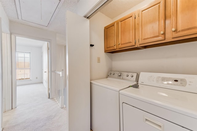 laundry area with independent washer and dryer, light colored carpet, and cabinets