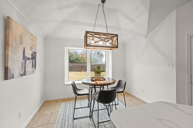 dining space with crown molding, vaulted ceiling, and light tile patterned flooring