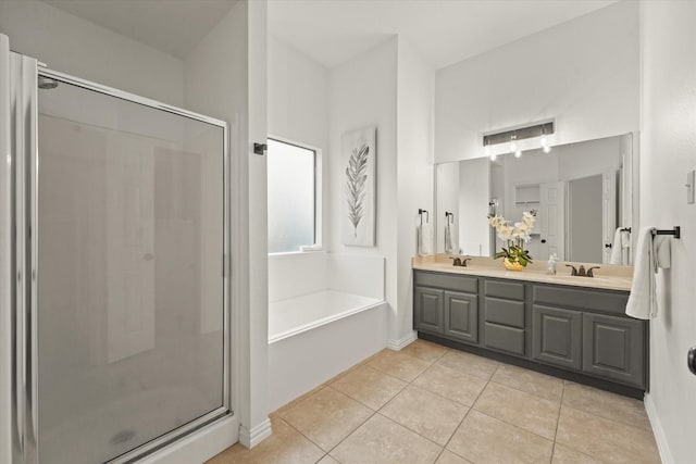 bathroom featuring tile patterned flooring, shower with separate bathtub, and vanity