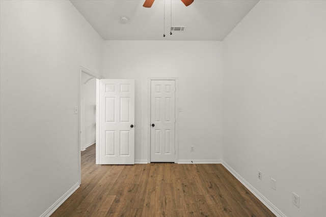 unfurnished bedroom with dark hardwood / wood-style flooring and ceiling fan