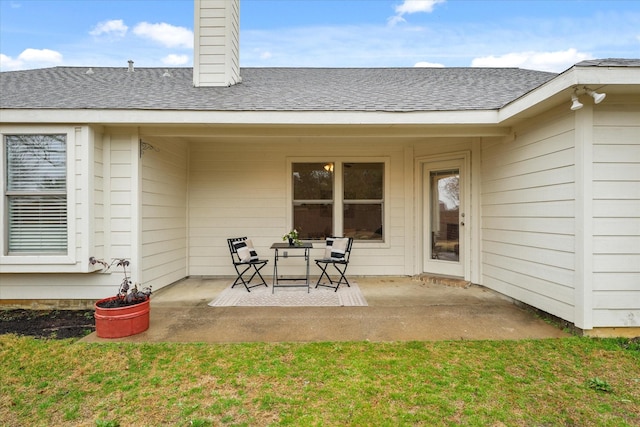 rear view of house featuring a patio and a yard