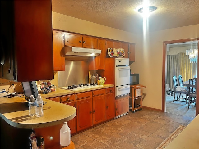 kitchen featuring white appliances and a textured ceiling