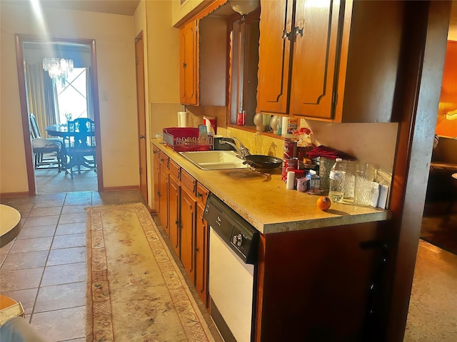 kitchen with sink, dishwasher, and light tile patterned flooring