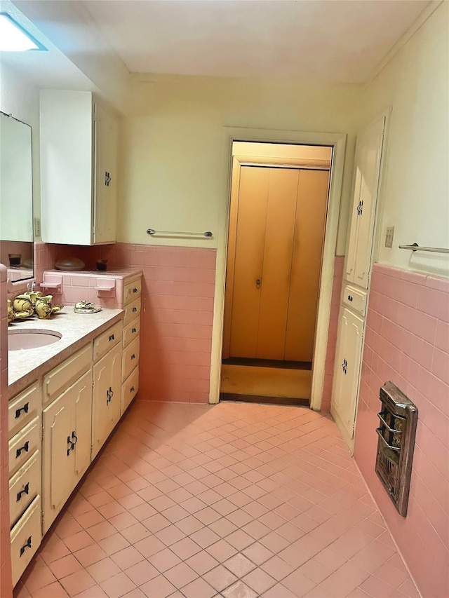 bathroom with vanity, tile patterned flooring, and tile walls