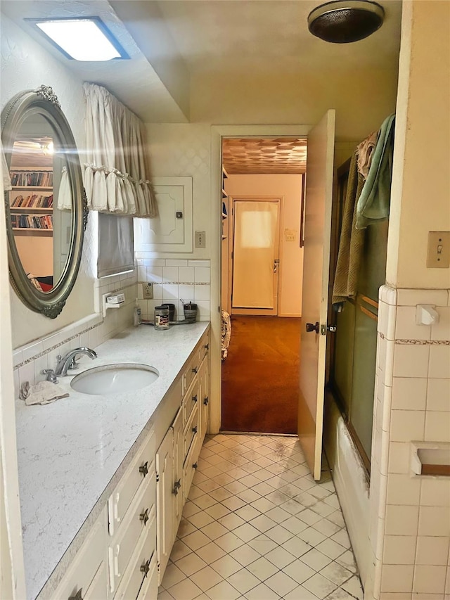 bathroom with tile patterned floors and vanity