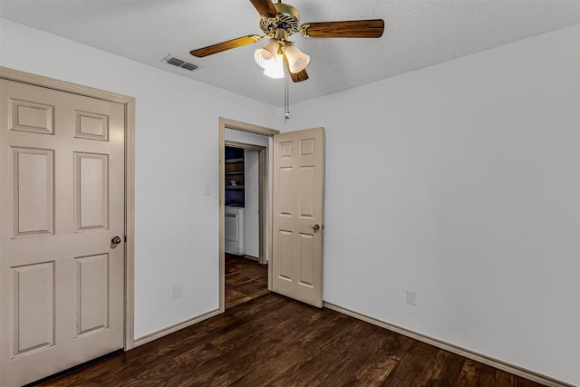 unfurnished bedroom featuring ceiling fan, dark hardwood / wood-style flooring, and a textured ceiling