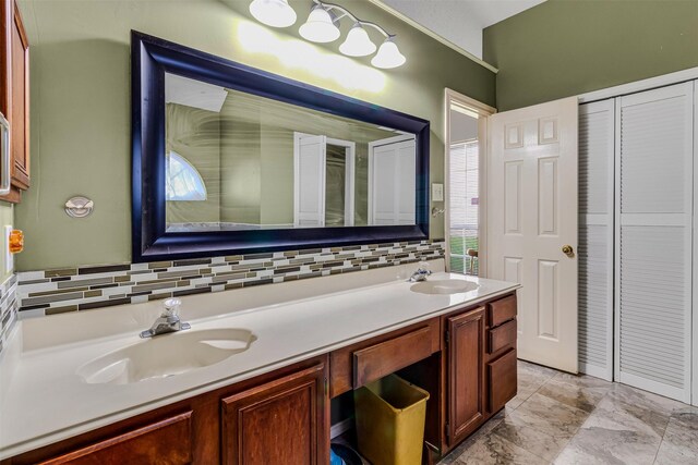 bathroom with vanity and decorative backsplash