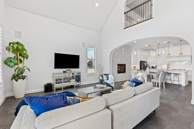 living room with high vaulted ceiling