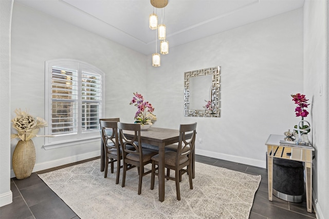 dining room featuring dark tile patterned flooring