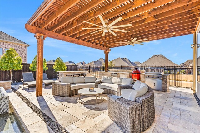 view of patio / terrace featuring ceiling fan, a pergola, outdoor lounge area, area for grilling, and exterior kitchen