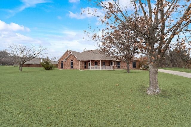 ranch-style home with covered porch and a front lawn