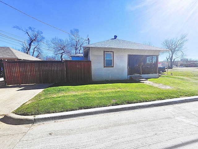 view of side of home featuring a yard