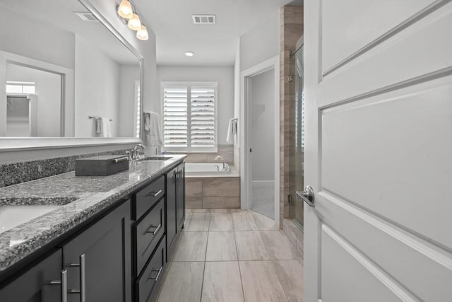 bathroom with vanity and separate shower and tub