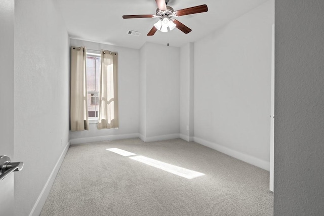 carpeted empty room featuring ceiling fan