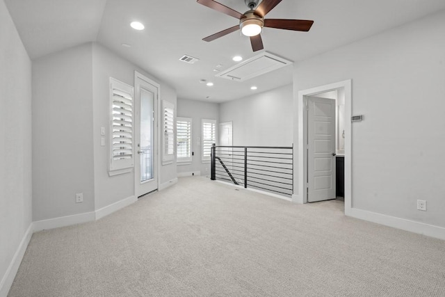 spare room featuring lofted ceiling, light colored carpet, and ceiling fan