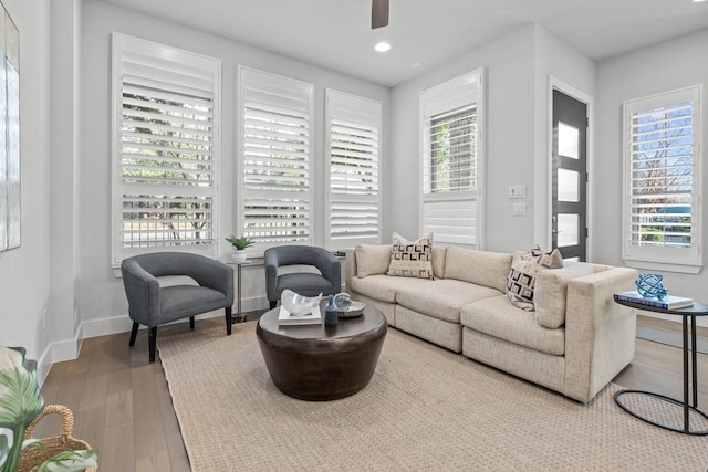 living room featuring hardwood / wood-style flooring and ceiling fan