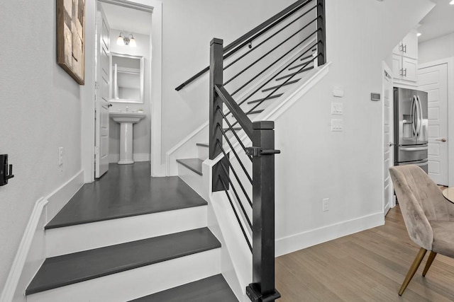 stairs with hardwood / wood-style floors