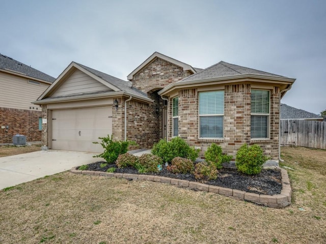 ranch-style home featuring a garage, central AC, and a front lawn