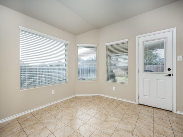 tiled foyer entrance featuring lofted ceiling