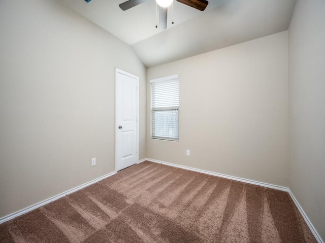 carpeted spare room with lofted ceiling and ceiling fan