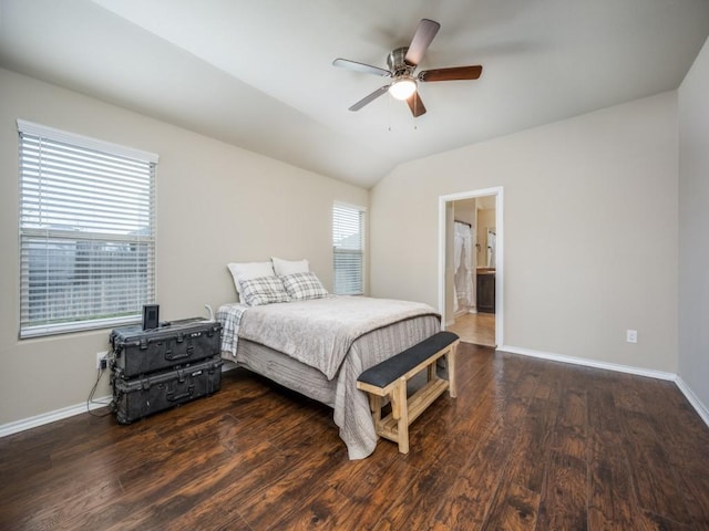 bedroom with ceiling fan, lofted ceiling, dark hardwood / wood-style flooring, and connected bathroom