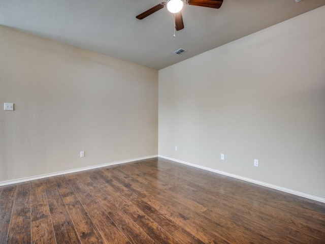 empty room with ceiling fan and dark hardwood / wood-style flooring