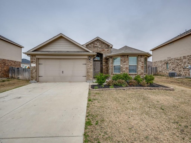 view of front of property with a garage, central AC unit, and a front lawn