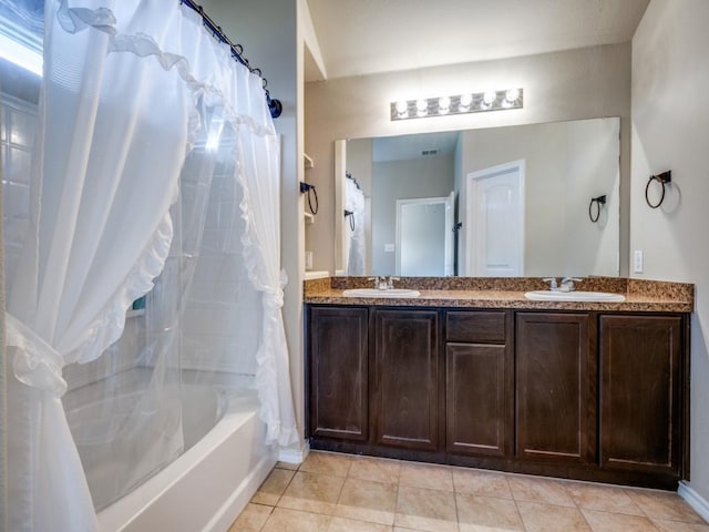 bathroom with shower / bath combo, tile patterned floors, and vanity