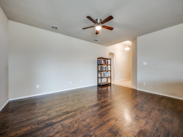 unfurnished room featuring dark hardwood / wood-style floors and ceiling fan