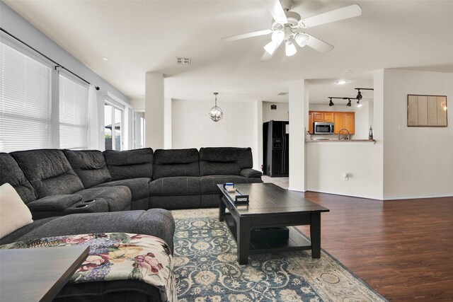 living room featuring ceiling fan, rail lighting, and hardwood / wood-style floors