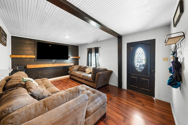 living room with beamed ceiling and dark hardwood / wood-style flooring