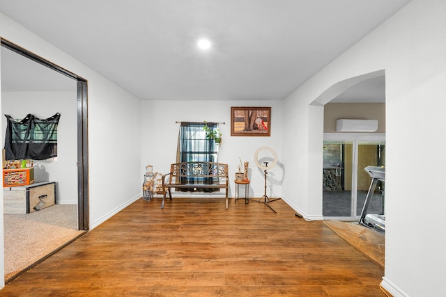 sitting room with wood-type flooring