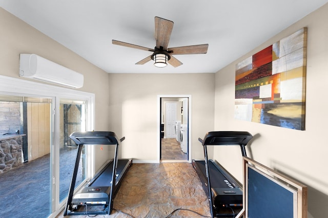 exercise room with ceiling fan, washing machine and dryer, and a wall mounted AC