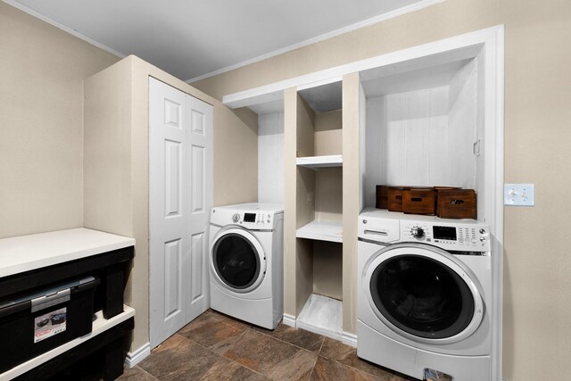 clothes washing area featuring ornamental molding and washing machine and clothes dryer