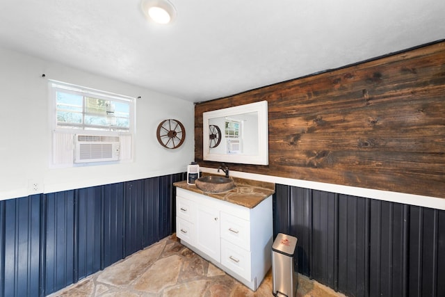 bathroom with vanity, cooling unit, and wood walls