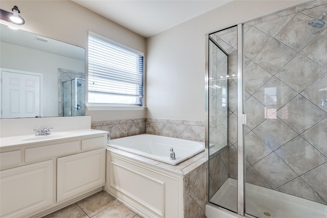 bathroom featuring vanity, tile patterned floors, and plus walk in shower