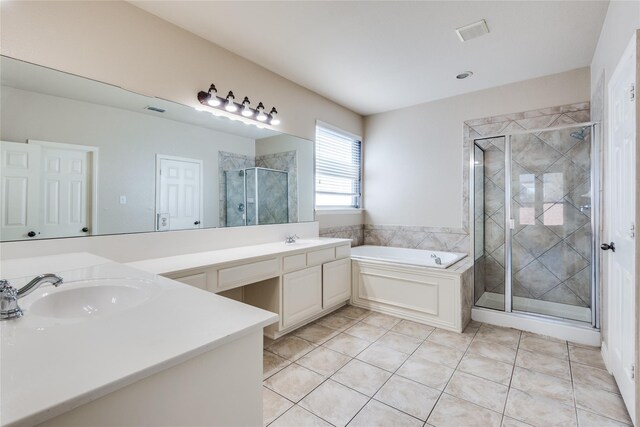 bathroom featuring vanity, tile patterned flooring, and plus walk in shower