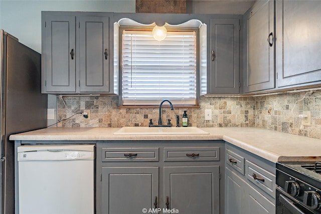 kitchen with dishwasher, sink, and gray cabinetry