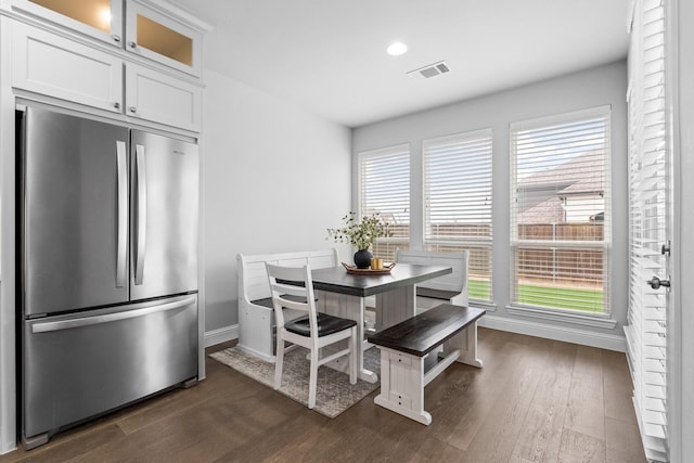 dining space with dark hardwood / wood-style flooring